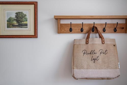 a tote bag hanging on a wall next to a picture at Pickle Pot Loft- 2 bedroom apartment in Hawkshead in Hawkshead