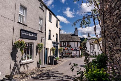 an empty street in a small town with buildings at Pickle Pot Loft- 2 bedroom apartment in Hawkshead in Hawkshead