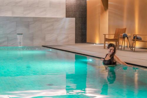 a woman in a swimming pool at Vila Vicência in Funchal