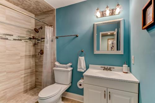 a bathroom with a toilet and a sink and a shower at Walk to Beach-Fernandina Shores 6513-Pool & Tennis-On North End Near Main Beach in Fernandina Beach