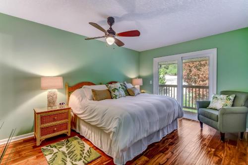a bedroom with a bed with a ceiling fan and a chair at Walk to Beach-Fernandina Shores 6513-Pool & Tennis-On North End Near Main Beach in Fernandina Beach