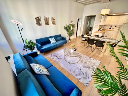a living room with a blue couch and a table at Art of living [Luxury House in Como] in Como