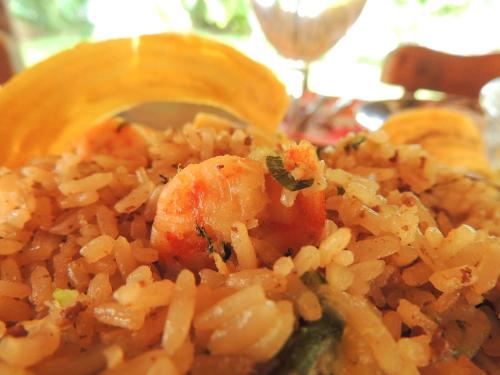 a plate of rice and shrimp with a spoon at Portoazul Casa de Playa in Puerto Colombia