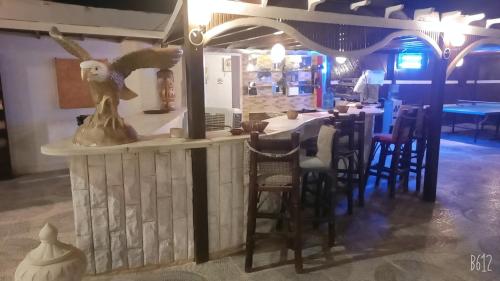 a restaurant with a statue of an eagle on the counter at Dolphin Continental Hotel in Quseir