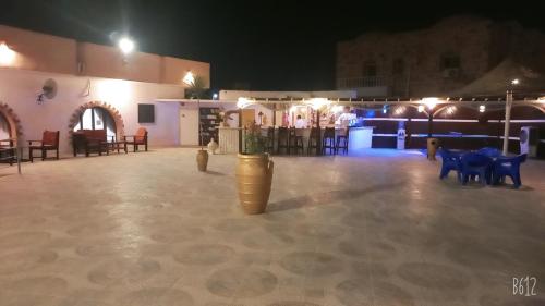 a large room with tables and chairs in a building at Dolphin Continental Hotel in Quseir