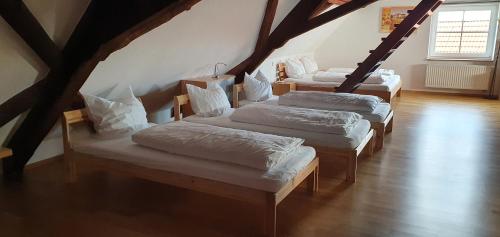 three beds in a room with a attic at Landgasthof Krone in Senden