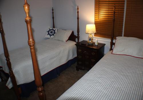 a bedroom with two beds and a lamp on a night stand at Navarre Beach Escapades-Pet Friendly in Navarre