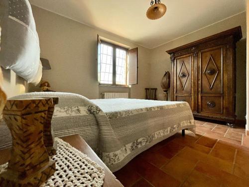 a bedroom with a large bed and a window at Il Sartore in Vetralla