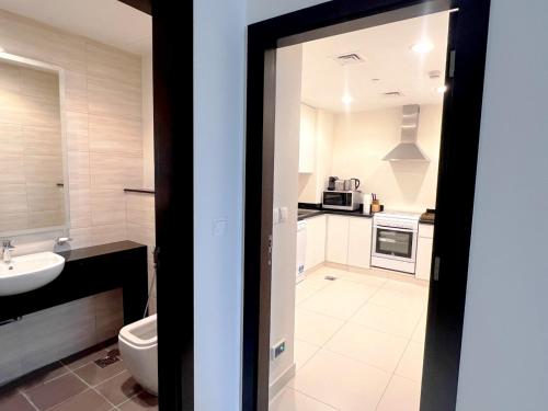 a bathroom with a toilet and a sink at Lovely one bedroom apartment with world class hotel amenities in Dubai
