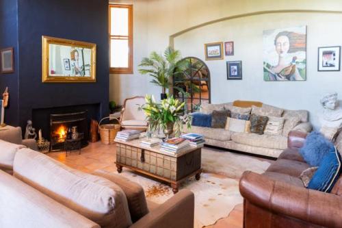 a living room with couches and a fireplace at Antria Boutique Lodge in Blenheim