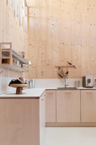 a kitchen with wooden cabinets and a plate of food on a counter at Noorderbed in Amsterdam