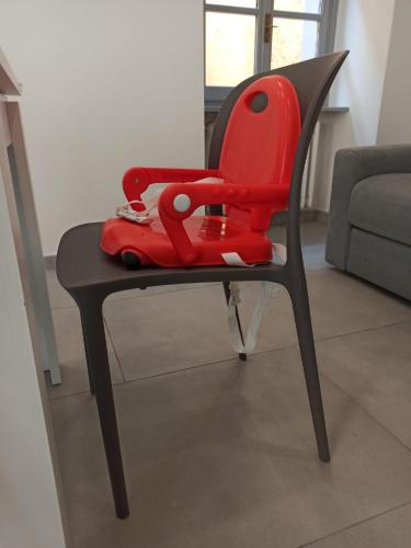 a red chair with a toy car on it at Dream Baveno in Baveno