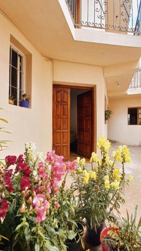 a bunch of flowers in front of a building at El Caucillar in Iruya