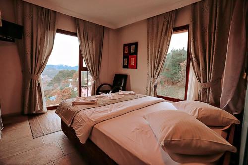 Postel nebo postele na pokoji v ubytování Gödence Hotel Restoran Bungalow