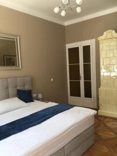 a bedroom with a large bed with a blue pillow at Apartment Vertigo in Karlovy Vary