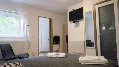 a bedroom with a bed and a window and a mirror at Aeroport - Relax Casa Victoria in Otopeni
