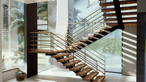 a wooden spiral staircase in a house with a window at Casa Amigos - By Pura Villas in Dominical