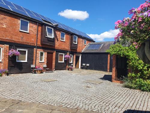 a courtyard with brick buildings and solar panels at Tennyson Retreat in Lincoln