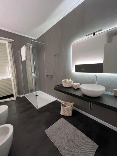 a bathroom with two sinks and a large mirror at Studio 55 in Aosta