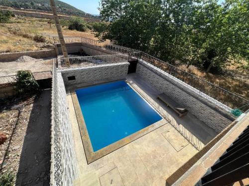 an overhead view of a swimming pool with a fence around it at Chalet Snow Valley - Private Pool in Imouzzer Kandar
