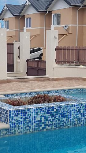 a swimming pool in front of some houses at de Felice in Mount Pleasant