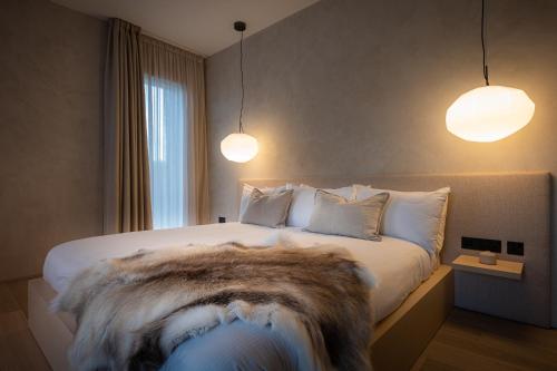 a bedroom with a large bed with a faux fur blanket at Vriskaig Luxury Guest Suite with Iconic Views in Portree