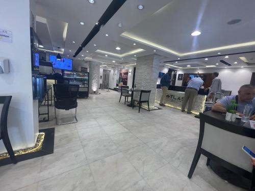 a lobby of a restaurant with tables and chairs at Atlas International Hotels in Cairo