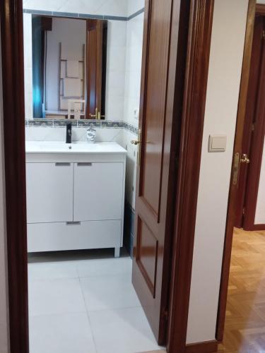 a bathroom with a white sink and a mirror at Casa Navarro in Vigo