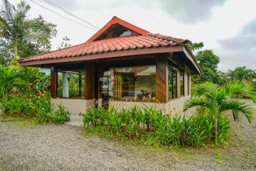 a small house with a red roof at Arenal History INN in Fortuna