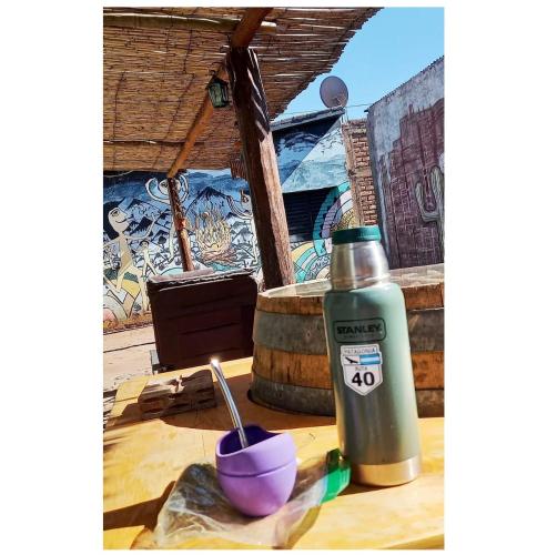 a bottle of water and a bowl on a table at Hospedaje Familiar Raza Mistica in Villa Unión