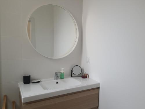 a bathroom with a white sink and a mirror at Exotic Fusion: Coffee & Radio in Lisbon