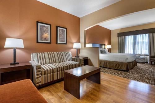 a hotel room with a bed and a couch at Best Western Plus Chelsea Hotel in Monticello