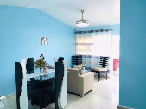 uma sala de jantar com paredes azuis e uma mesa e cadeiras em Apto 2Habitaciones con Aire y Vista al Malecón de Samaná em Santa Bárbara de Samaná