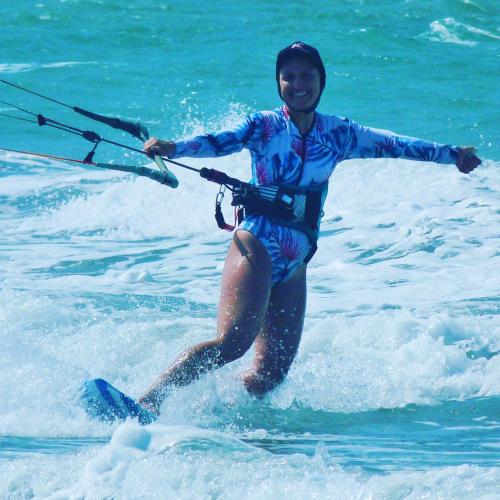 a woman is in the water on water skis at Pousada Casa Azul do Piauí in Luis Correia