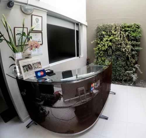 een kantoor met een glazen bureau in een kamer bij Hotel Parque Reservado in Pasto