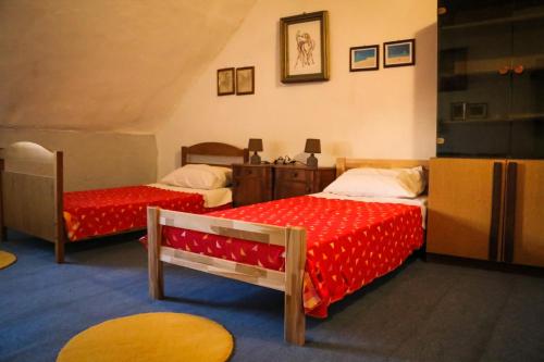 a bedroom with two beds with red sheets at Holiday house with a parking space Bobovisca, Brac - 11435 in Ložišće