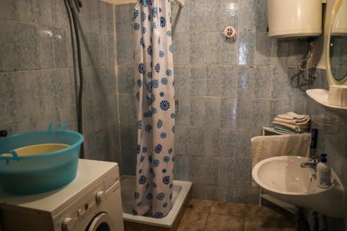 a bathroom with a sink and a shower curtain at Holiday house with a parking space Bobovisca, Brac - 11435 in Ložišće