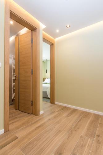 an empty room with a door and a bedroom at Mayisa Apartments in Sarajevo
