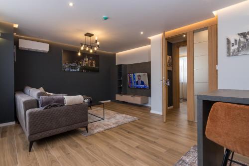 a living room with a couch and a tv at Mayisa Apartments in Sarajevo