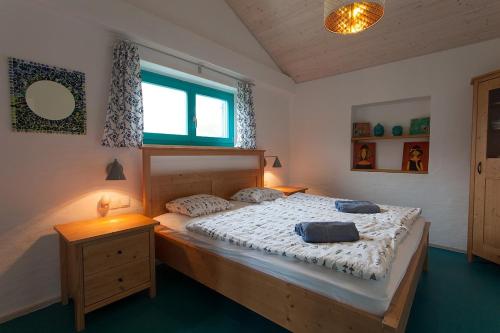 a bedroom with a bed with two pillows on it at Holiday house with a parking space Kornic, Krk - 11504 in Kornić