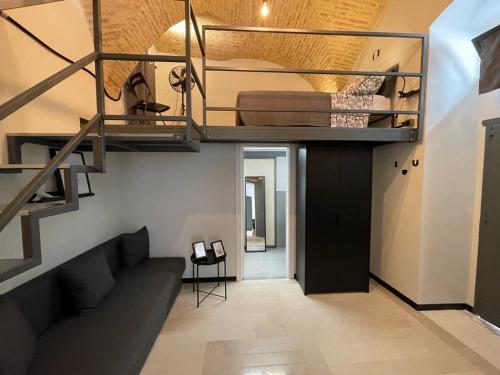 a living room with a loft bed and a couch at Dimora Anelli in Vasto