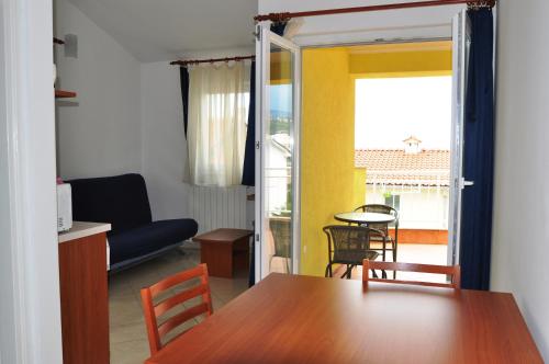 a dining room with a table and chairs and a living room at Apartments with a parking space Selce, Crikvenica - 11527 in Selce