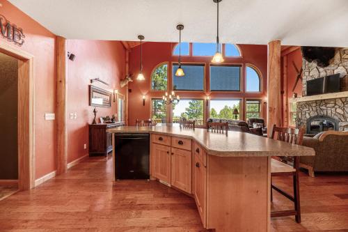 a kitchen with orange walls and a large kitchen island at Ridgeview Retreat in Sturgis