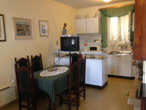 a kitchen with a table and chairs and a kitchen with a sink at Seaside holiday house Prigradica, Korcula - 11484 in Blato