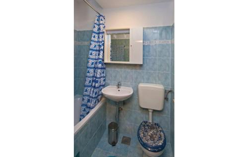 a bathroom with a sink and a toilet at Apartments with a parking space Fazana - 13761 in Marana