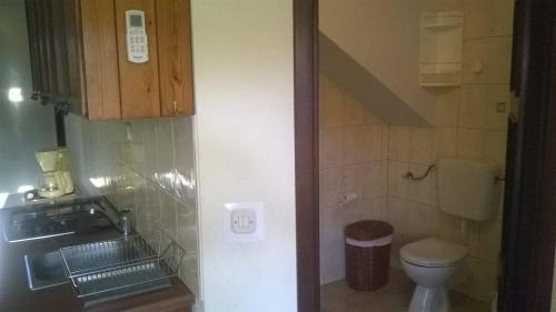 a small bathroom with a toilet and a sink at Seaside holiday house Vrboska (Hvar) - 13813 in Vrboska