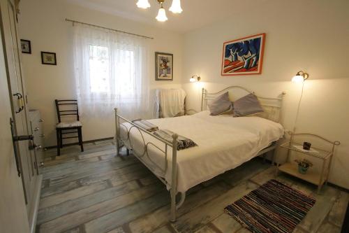a bedroom with a bed and a window at Apartments by the sea Vinjerac, Zadar - 13811 in Posedarje