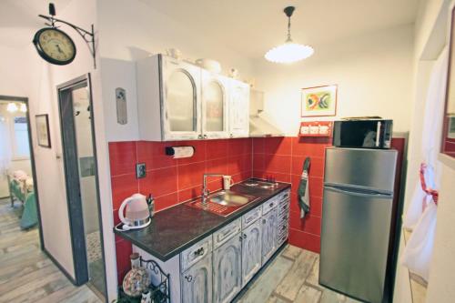 a kitchen with a sink and a refrigerator at Apartments by the sea Vinjerac, Zadar - 13811 in Posedarje