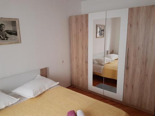 a bedroom with two beds and a mirror at Apartments with a parking space Omis - 13785 in Omiš
