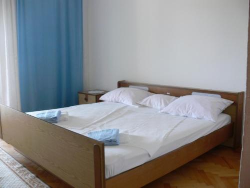 - une chambre avec un lit doté de draps et d'oreillers blancs dans l'établissement Apartments with a parking space Grebastica, Sibenik - 13860, à Bašelovići